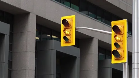Traffic lights changing light from green to yellow and red in the street with Stock Footage 224732494