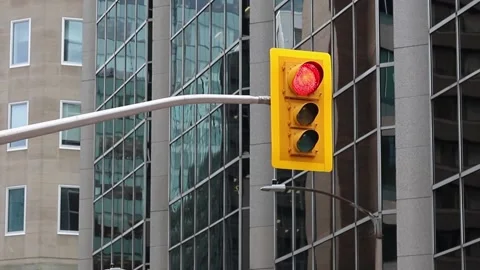 Traffic lights changing light from red to green in the street with buildings in Stock Footage 224732387