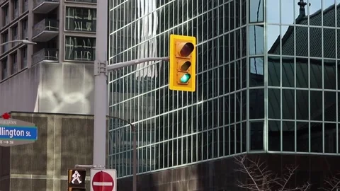 Traffic lights changing light from red to green in the street with buildings in Stock Footage 224928075