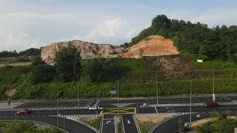 Traffic lights, intersections, vehicles moving, eroded hill at Puncak Perdana Stock Footage 230061004