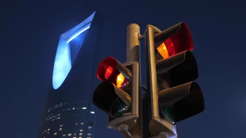 Traffic lights with Kingdom Tower in Riyadh, Saudi Arabia at night Stock Footage 316552898