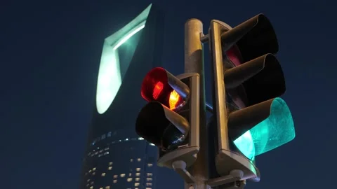 Traffic lights with Kingdom Tower in Riyadh, Saudi Arabia at night 動画素材 316552930