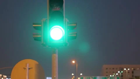 Traffic lights with Kingdom Tower in Riyadh, Saudi Arabia at night 動画素材 316553563
