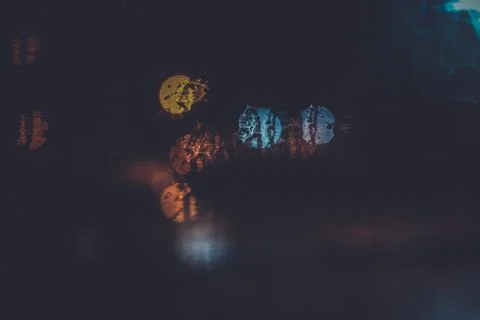 Traffic lights through the window in a rainy night Stock Photos