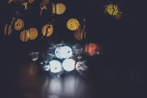 Traffic lights through the window in a rainy night Stock Photos