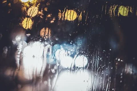 Traffic lights through the window in a rainy night Stock Photos