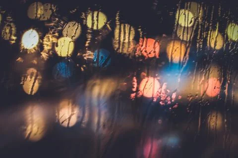 Traffic lights through the window in a rainy night Stock Photos