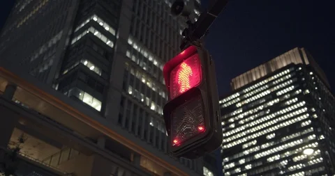 Traffic lights under buildings at night in Tokyo Japan. Stock Footage