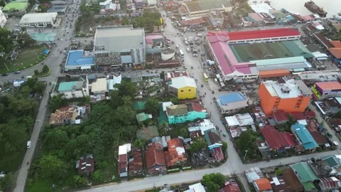 Traffic on long street roads among city buildings in summer Stock Footage 248281053