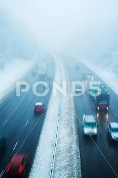 Traffic On Motorway During Snow Storm Stock Photos