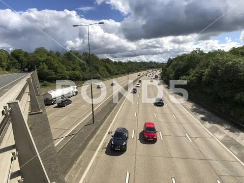 Traffic on motorway, sunny day big clouds Stock Photos