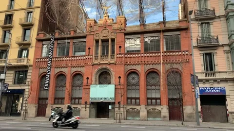 Traffic movement in front of Fundacio Antoni Tapies Museum. Barcelona Stock Footage 167841865