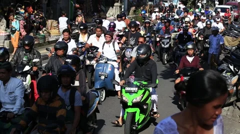 Traffic moves slowly along a busy road in Ubud. Island Bali, Indonesia Stock Footage