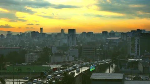 Traffic moves through Addis Ababa at sunset Stock Footage 293503965