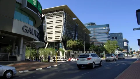 Traffic moving along intersection in Sandton city Stock Footage 100662450