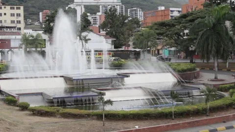 Traffic moving around a large public fountain in Cali, Colombia Stock Footage 122307688