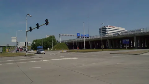 Traffic moving in between the highway A10 and the Amsterdam Sloterdijk business Stock Footage 131336789