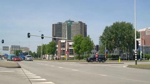 Traffic moving in between the highway A10 and the Amsterdam Sloterdijk business Stock Footage 131336966