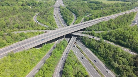 Traffic Moving on Complex Highway Interchange Through Green Nature Stock Footage 336632060