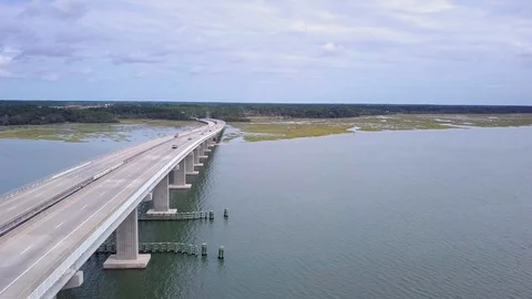 Traffic moving over double bridge over water, slider action drone shot Stock Footage 96540466