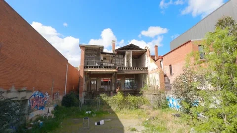 Traffic moving through abandoned facade, 4K Stock Footage 138680891