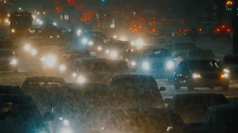 Traffic is moving through epic snowfall, snowstorm in city. Stock Footage 125680814