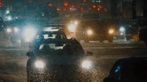 Traffic is moving through epic snowfall, snowstorm in city. Stock Footage 125858540