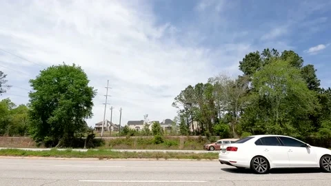 Traffic on a multi lane highway in super slow motion brown hearse passing Stock Footage 180132405
