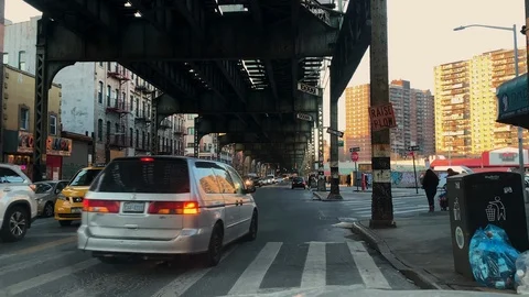 Traffic Navigates driving under the Elevated Subway Train Overpass in Brooklyn Stock Footage 122402832