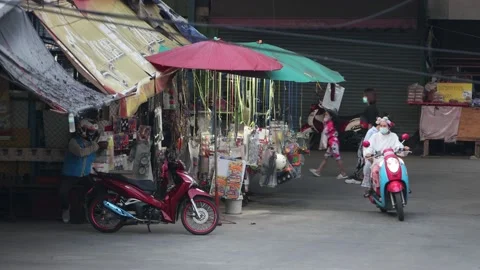 Traffic next to a lighted toy stall at dusk Stock Footage 220050883