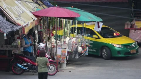 Traffic next to a lighted toy stall at dusk Video stock 220565782