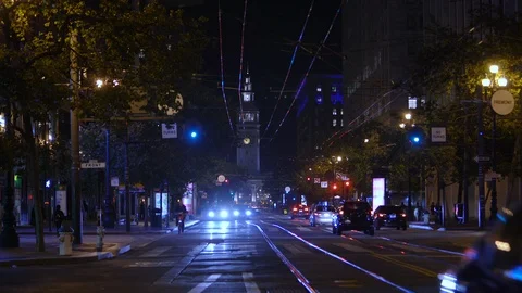 Traffic at night, Market Street, San Francisco. Clocktower building in back. Stock Footage