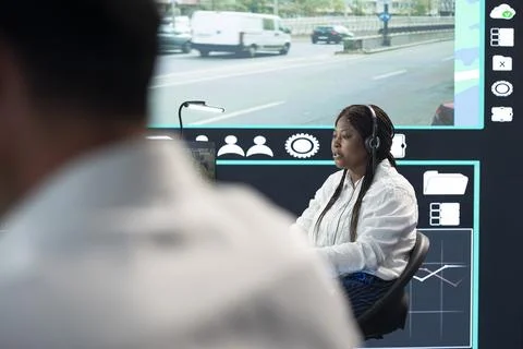 Traffic operator using headset mic to report congestion incidents Stock Photos