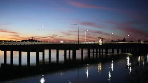 Traffic Over A River Bridge At Sunset Stock Footage 131277547