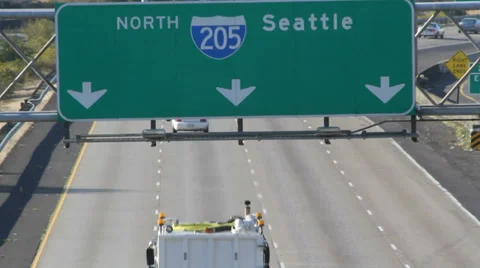 Traffic passes beneath 'North to Seattle' sign Stock Footage