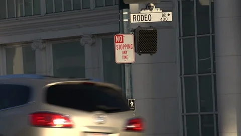 Traffic passing beneath the Rodeo Drive sign Beverly Hills California Stock Footage 124175737