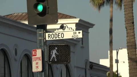 Traffic passing beneath the Rodeo Drive sign, Beverly Hills California Stock Footage 124176350