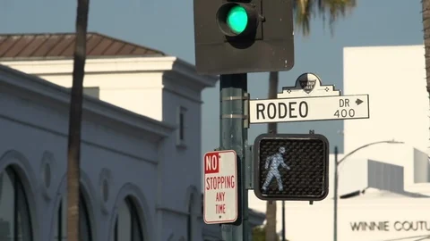 Traffic passing beneath the Rodeo Drive sign, Beverly Hills California Stock Footage 124176382