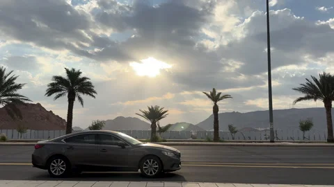 Traffic Passing Beneath Sun Rays Through Clouds 스톡 동영상 342568909