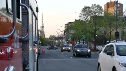 Traffic passing in direction of the camera close of firetruck Stock Footage 90359940