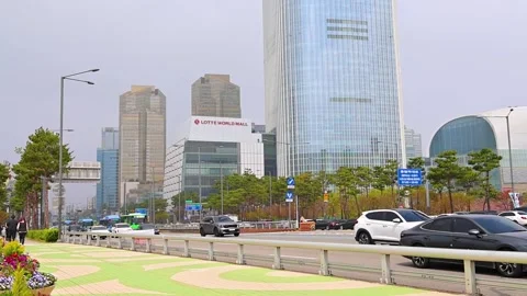 Traffic Passing Lotte World Tower and Lotte World Mall in Seoul South Korea.. Stock Footage 336440429