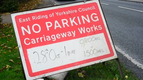 Traffic passing no parking warning sign of roadworks bubwith yorkshire uk Stock Footage 164525645