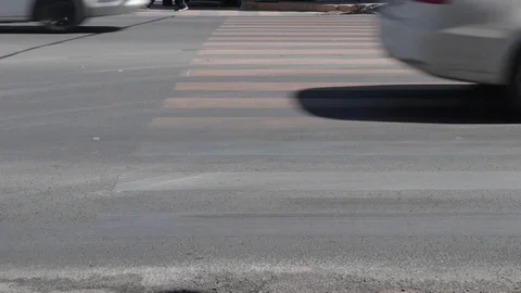 Traffic passing over a worn-out yellow pedestrian cross Video stock 106203489