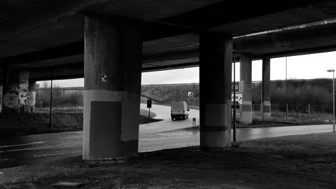 Traffic passing by the pillars of a highway bridge. Stock Footage 171799148