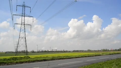 Traffic passing power generating windmills by Drax power station yorkshire uk Stock Footage 49849605