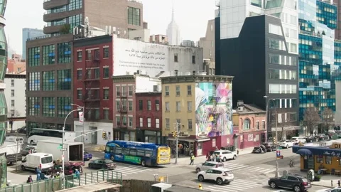 Traffic passing through intersection in front of apartment buildings Stock-Footage 241377132