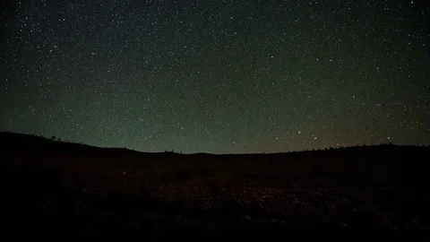 Traffic Passing Under a Starry Night Sky Video stock 76642009