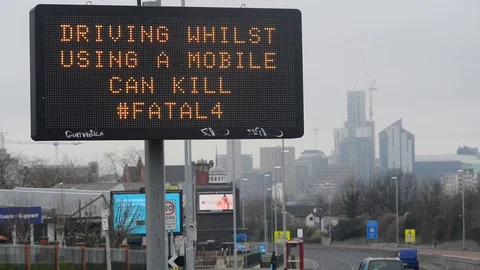 Traffic passing waring sign of using mobile phones while driving Stock Footage 126580840