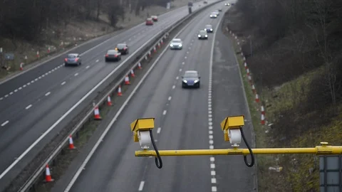 Traffic passing warning sign of average speed cameras uk Stock Footage 88084417