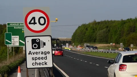 Traffic passing warning sign of average speed cameras uk Stock Footage 90371069